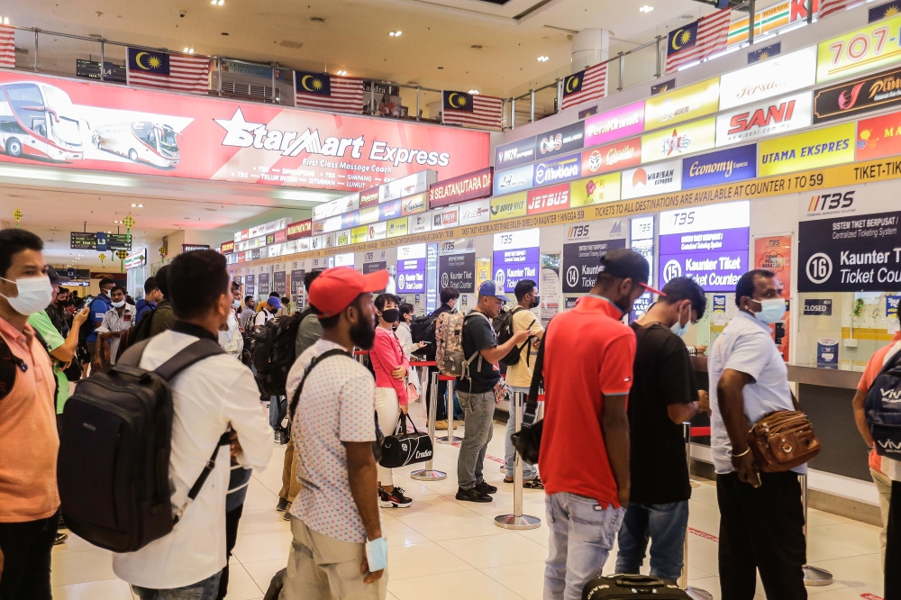 Some who had bought their tickets online still had to join the queue together with some others who had bought their tickets directly from the bus companies who had set up counters for last-minute sales. — Pictures by Sayuti Zainudin