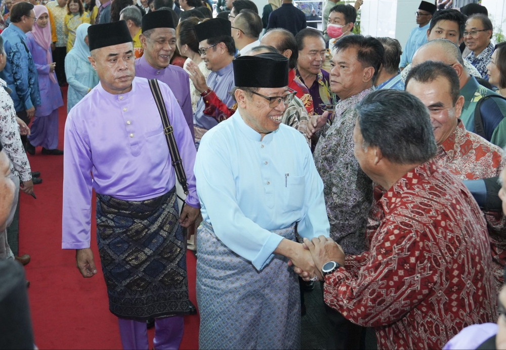 Abang Johari greets Tan Sri William Mawan and other guests at the open house. — Picture by Chimon Upon/Borneo Post