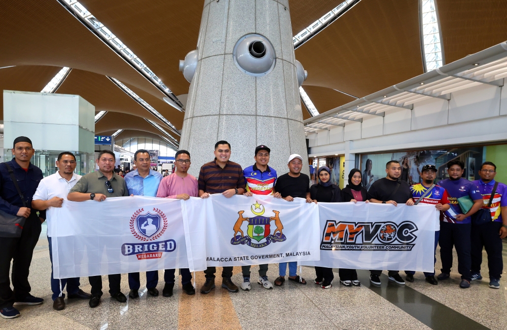 Melaka Rural Development and Food Security Committee chairman Dr Muhamad Akmal Saleh (6th left) Briged Negaraku president Khairul Nizam Mohd Sopery (5th left) pose for a picture with participants before departure to Turkiye from Kuala Lumpur International Airport in Sepang April 24, 2023. — Bernama pic