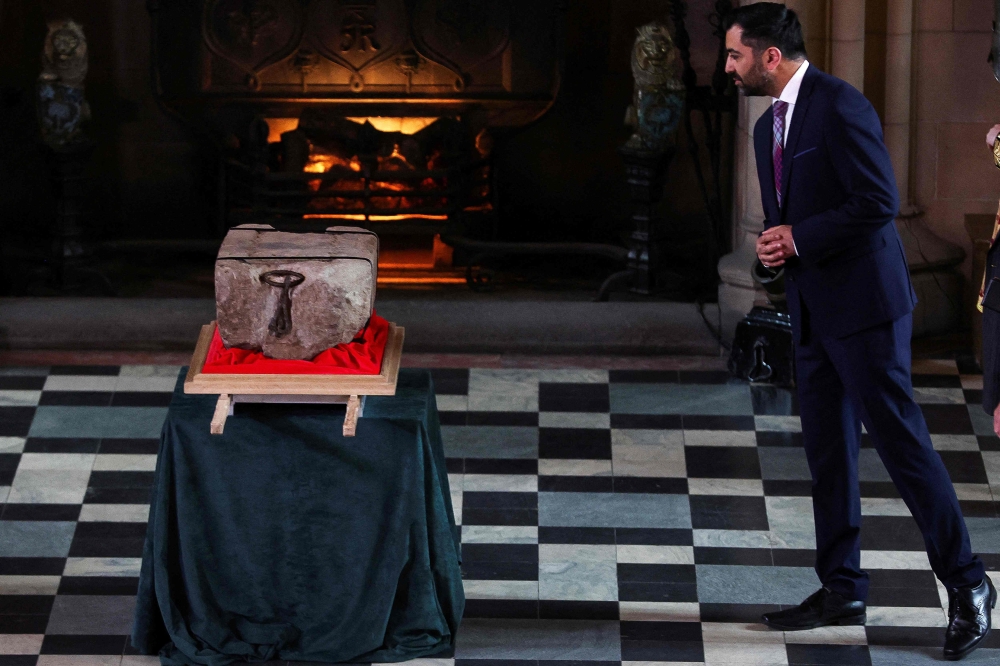 Scotland's First Minister Humza Yousaf looks at the Stone of Destiny during a special ceremony at Edinburgh Castle on April 27, 2023 before it is transported to Westminster Abbey for the Coronation of Britain's King Charles III. — Russell Cheyne/Pool /AFP pic