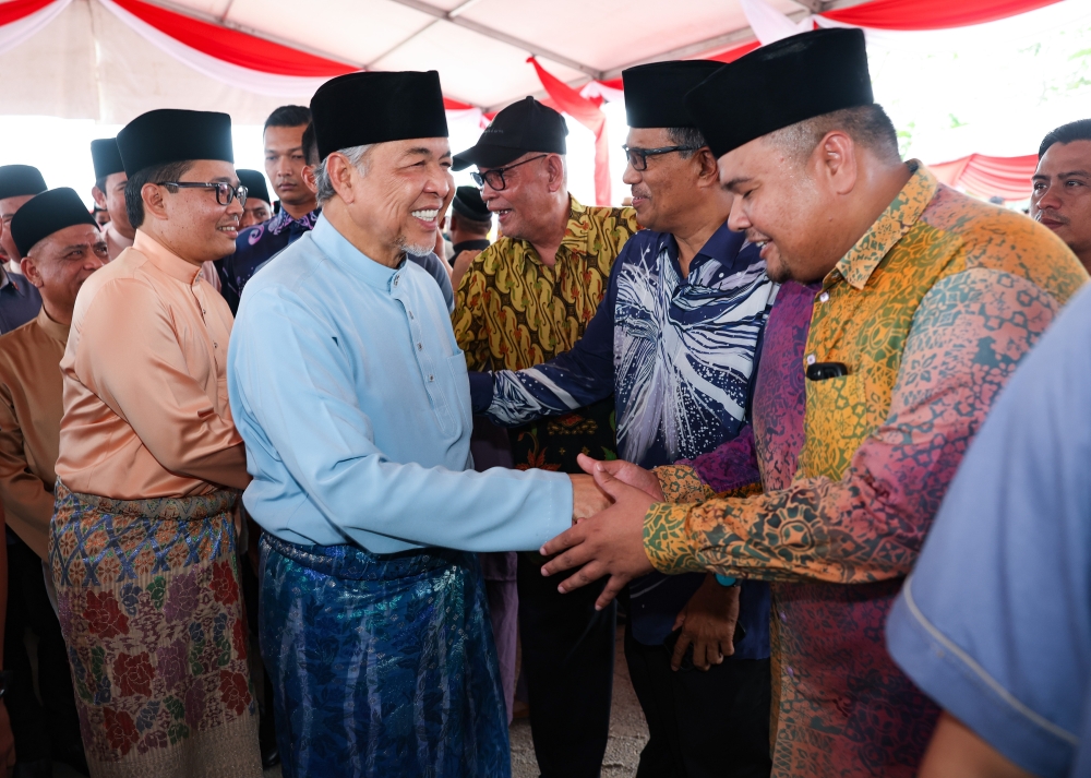 Deputy Prime Minister and Umno president Datuk Seri Ahmad Zahid Hamidi greets guests at the Pasir Salak Umno division Aidilfitri open house in Kampong Gajah April 29, 2023. — Bernama pic