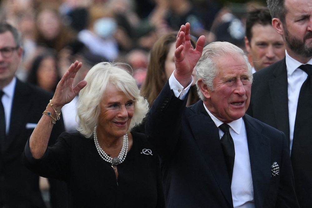 File photo of Britain’s King Charles III (right) and Britain’s Camilla, Queen Consort waving as they greet the crowd upon their arrival Buckingham Palace in London September 9, 2022. — AFP pic