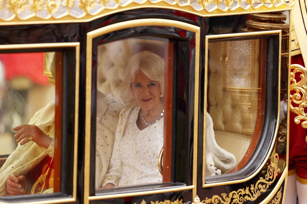 Britain's King Charles III and Britain's Camilla, Queen Consort travel in the Diamond State Coach, in the 'King's Procession', a journey of two kilometres from Buckingham Palace to Westminster Abbey in central London on May 6, 2023, ahead of their coronations. — AFP pic