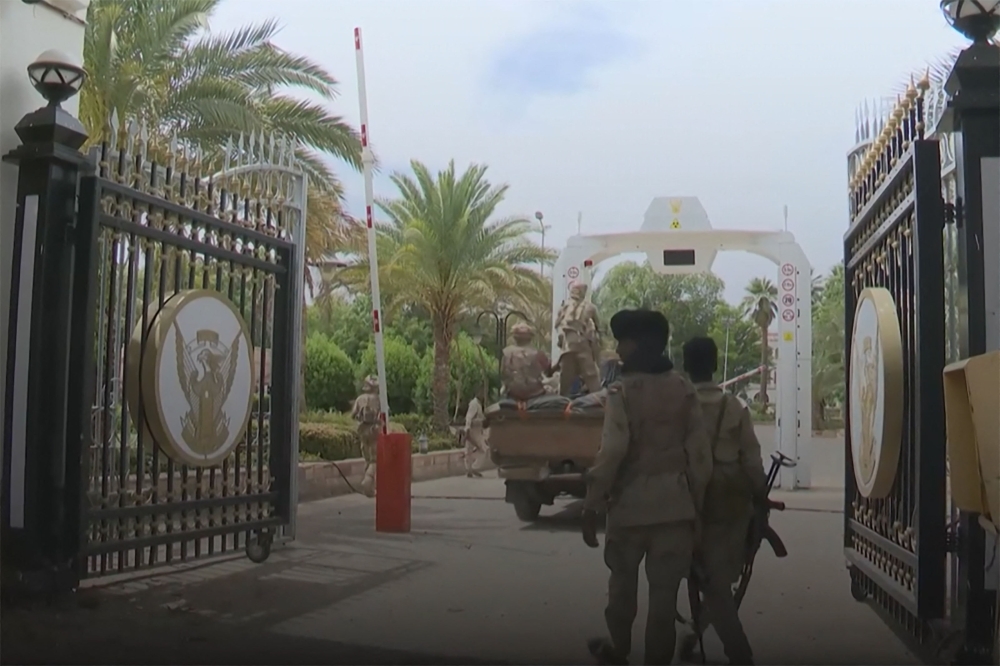 In this image grab taken from footage released by the Sudanese paramilitary Rapid Support Forces (RSF) on May 1, 2023, fighters stand at an entrance of the presidential palace in Khartoum. — AFP pic