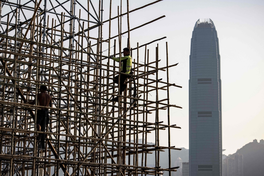 Scaffolders  constructing bamboo scaffolding in Hong Kong March 1, 2023. —  AFP pic