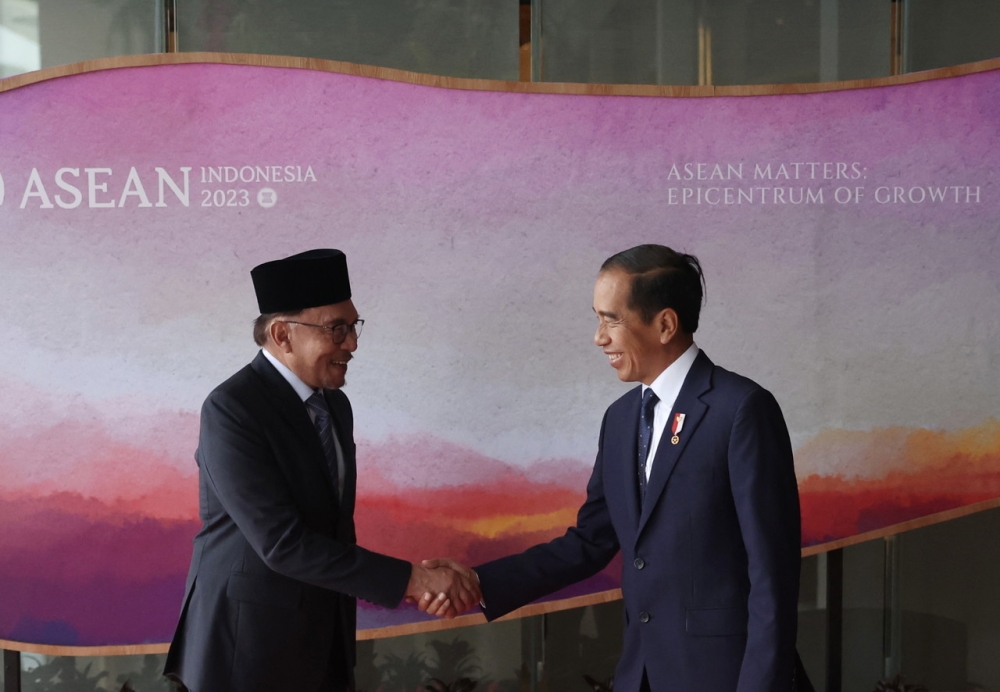 Prime Minister Datuk Seri Anwar Ibrahim (left) shakes hands with Indonesian President Joko Widodo during a bilateral meeting to attend the 42nd Asean Summit 2023 in West Manggarai town, Flores, Indonesia. — Bernama pic