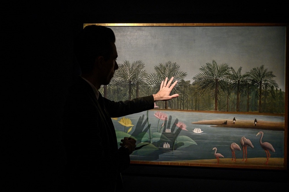 A Henri Rousseau painting entitled ‘Les Flamants’ that is estimated to fetch 20  —  30 million USD is displayed at Christie’s auction house in New York city on May 2, 2023. — AFP pic