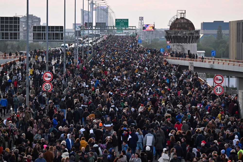 Protesters block a highway bridge during a rally to call for the resignation of top officials and the curtailing of violence in the media, just days after back-to-back shootings stunned the Balkan country, in Belgrade May 12, 2023.  — AFP pic