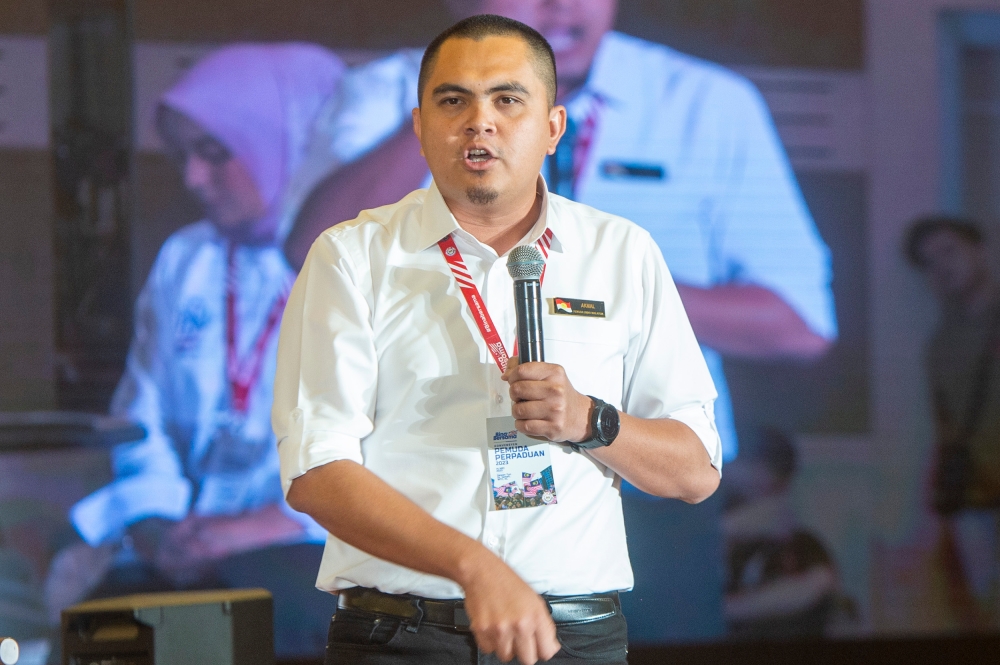 Umnol youth chief, Dr Muhamad Akmal Saleh delivers his speech at the National Unity Government Convention at World Trade Centre in Kuala Lumpur 14 May 2023. — Picture by Shafwan Zaidon