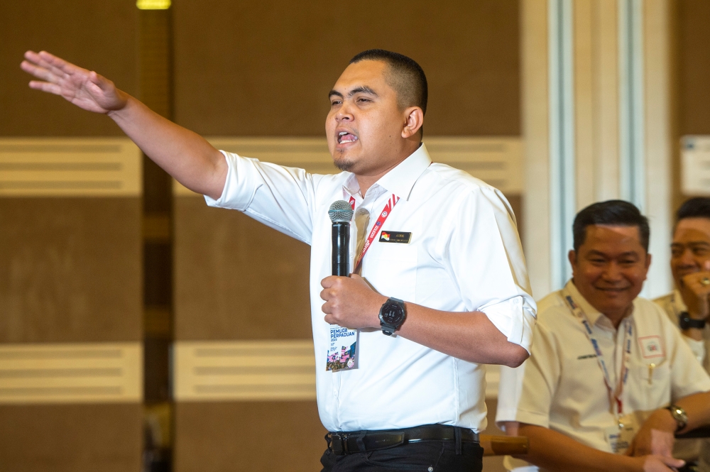 Umno youth chief Dr Muhamad Akmal Saleh delivers his speech at the National Unity Government Convention at World Trade Centre in Kuala Lumpur 14 May 2023. — Picture by Shafwan Zaidon