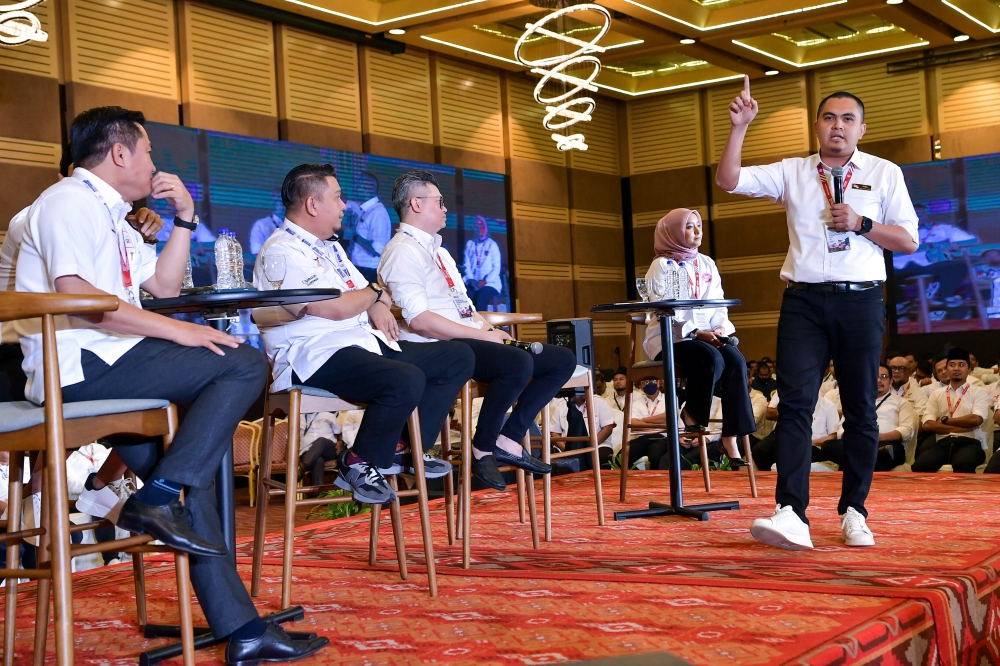 Gabungan Parti Sarawak (GPS) deputy youth chief Lukanisman Awang Sauni (right) speaks during the Unity Government National Convention at World Trade Centre Kuala Lumpur May 14, 2023. — Bernama pic