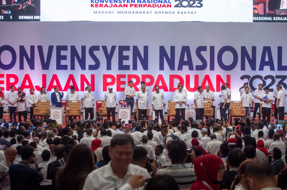 Putting decades of enmity aside, leaders from both sides yesterday made nice as they turned up dressed in white to the inaugural national convention for the coalition government calling itself unity government. — Picture by Shafwan Zaidon