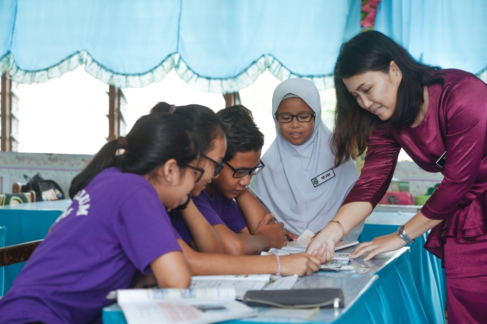 Teachers add the personal touch to a system which is filled with rules, requirements, ‘standards’ and formal techniques, all pushed down the throats of students. — Picture by Mukhriz Hazim