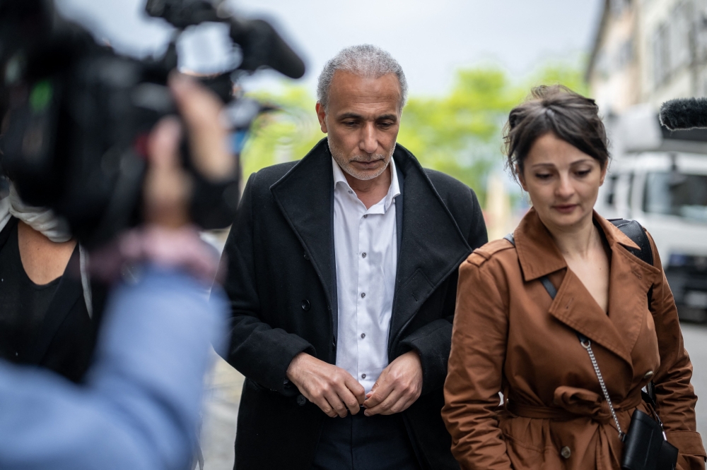 Swiss Islamic scholar Tariq Ramadan and his lawyer Nabila Asmane arrive on the second day of his trial at the Geneva court house on May 16. — AFP pic