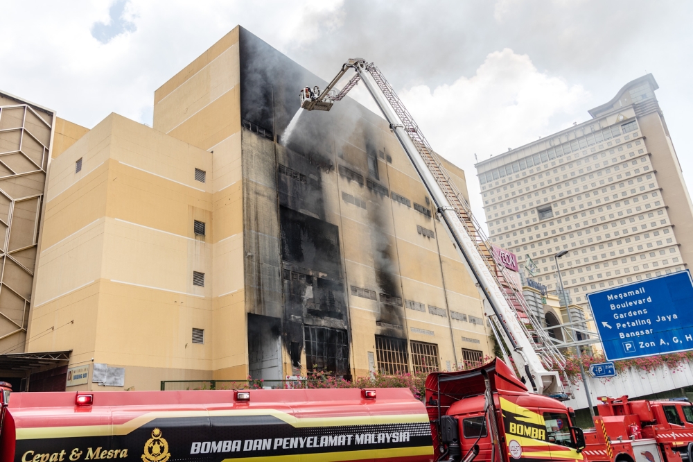 Fire and Rescue Department personnel putting out the fire at Mid Valley megamall in Kuala Lumpur May 17, 2023. — Picture by Firdaus Latif