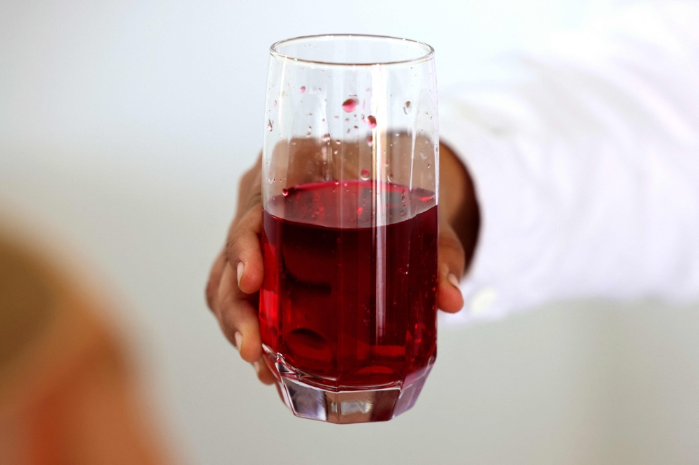 Zahraa Sayed Ahmed produces a syrup from Damascena (Damask) roses. — AFP pic