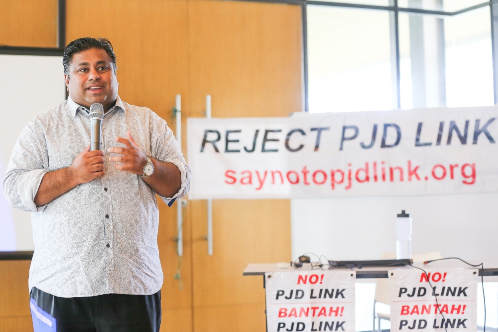 Bukit Gasing assemblyman Rajiv Rishyakaran speaks during the Petaling Jaya Dispersal Link (PJD Link) elevated highway project forum at Five Stones Condominium in Petaling Jaya May 20, 2023. — Picture by Yusof Mat Isa