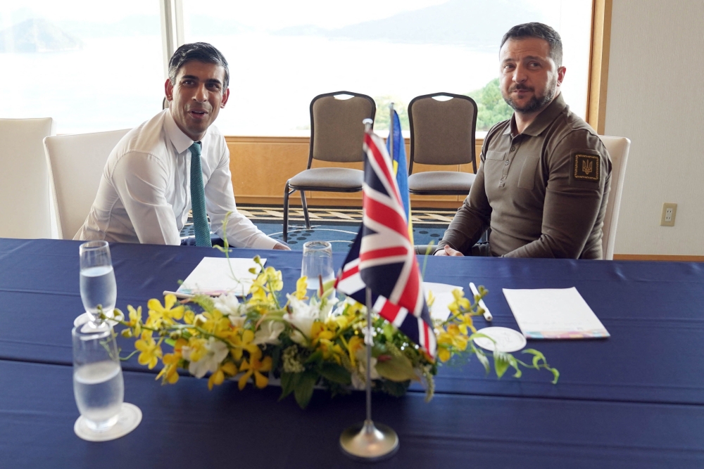 Britain’s Prime Minister Rishi Sunak (left) and Ukraine’s President Volodymyr Zelensky meet during the G7 Leaders’ Summit in Hiroshima on May 20, 2023. ― AFP pic