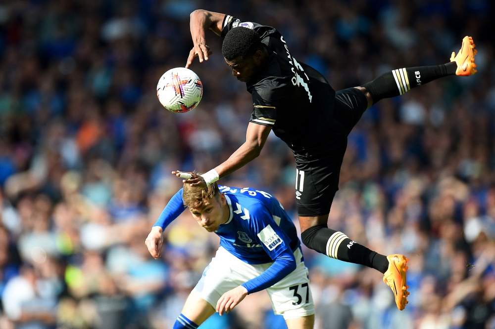 Everton's English midfielder James Garner (back) challenges Bournemouth's Burkinabe striker Dango Ouattara during the English Premier League football match between Everton and Bournemouth at Goodison Park in Liverpool, northwest England, on May 28, 2023. — AFP pic