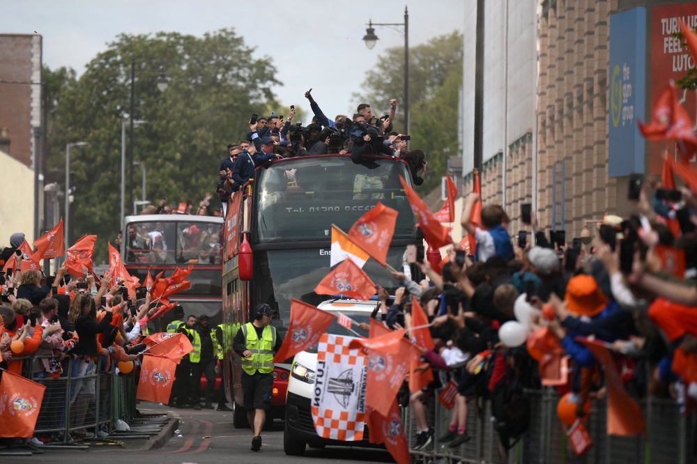 Luton Town football club players and staff parade through the streets of Luton with the Championship playoff trophy in Luton, north of London on May 29, 2023, as they celebrate their promotion to the English Premier League. — AFP pic