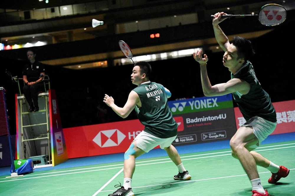 File photo of Aaron Chia (left) and Soh Wooi Yik of Malaysia playing a shot at the World Badminton Championships in Tokyo on August 28, 2022. — AFP pic