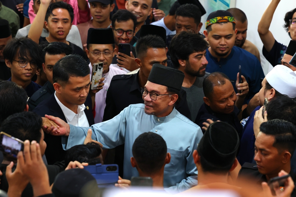 Prime Minister Datuk Seri Anwar Ibrahim greets the crowd after performing his Friday prayers at Masjid Raja Haji Fisabilillah in Cyberjaya June 16, 2023. ― Bernama pic