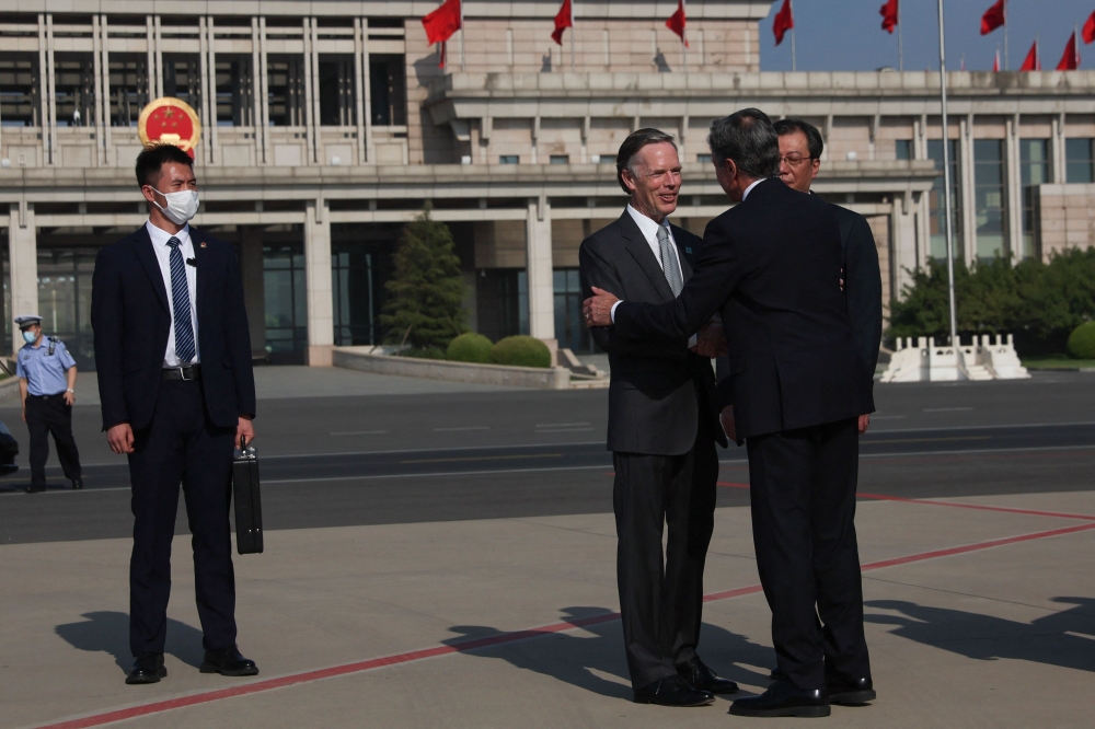 US Secretary of State Antony Blinken is welcomed by US Ambassador to China Nicholas Burns (left) and Director General of the Department of North American and Oceanian Affairs of the Foreign Ministry Yang Tao (right), as he arrives in Bejing, China, June 18, 2023. — AFP pic