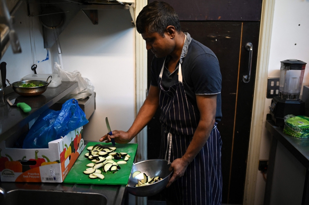 Staff prepare ingredients used in balti dishes in the kitchen of ‘Shababs’ restaurant in the ‘Balti Triangle’ area of Birmingham, central England on June 7, 2023. — AFP pic