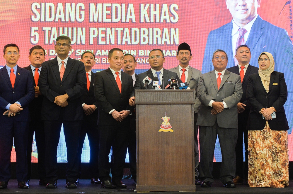 Selangor Menteri Besar Datuk Seri Amirudin Shari (centre) speaks during a press conference in  Shah Alam June 19, 2023.  — Picture by Miera Zulyana