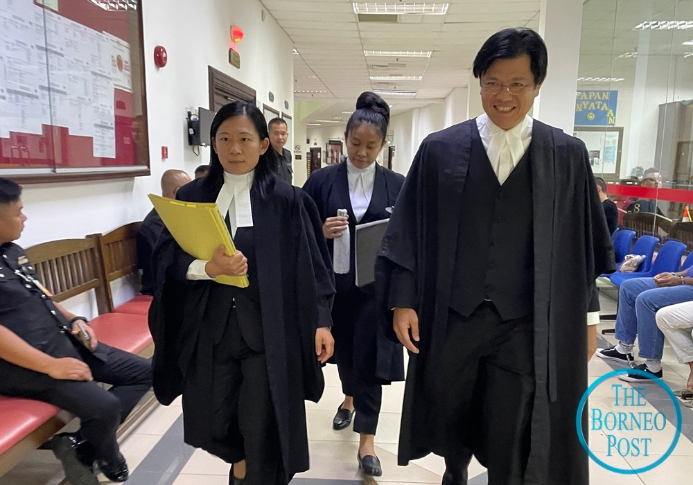 Alvin Yong (right), counsel for Toh Puan Datuk Patinggi Raghad Kurdi Taib, is seen at Kuching Court Complex today after the end of the proceedings. — Borneo Post pic   