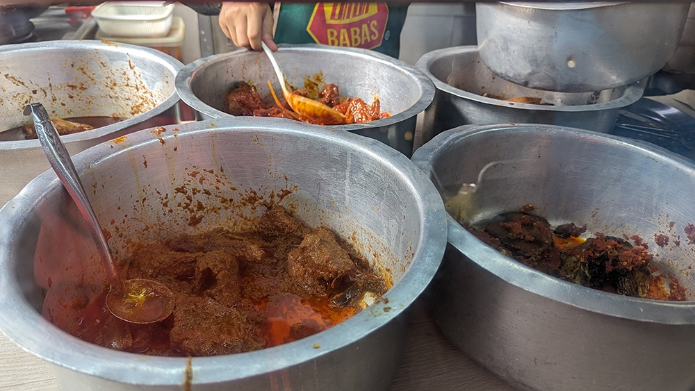 Like a child in a candy store, you can gaze longingly at the pots of 'lauk' while ordering.