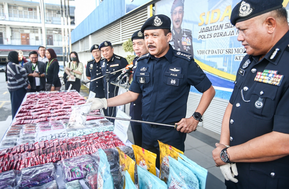 Perak police chief Datuk Seri Mohd Yusri Hassan Basri showing the drugs seized from a house in Jalan Medan Ipoh, at a press conference at the Perak police headquarters in Ipoh June 28, 2013. — Picture by Farhan Najib