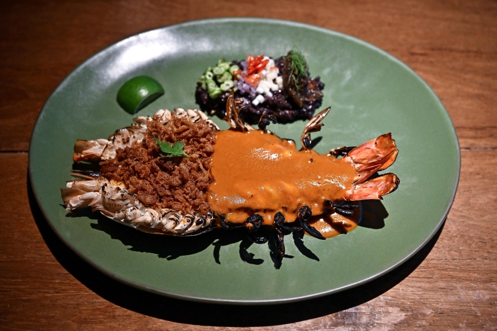 This photo taken on June 23, 2023 shows a shrimp paste rice-inspired river prawn dish by Michelin-starred Thai chef Thitid 