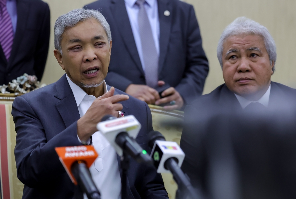 Deputy Prime Minister Datuk Seri Ahmad Zahid Hamidi (left) speaks during a press conference at Wisma Bapa Malaysia in Petra Jaya July 3, 2023. — Bernama pic