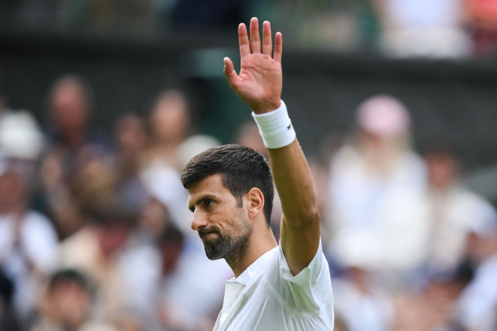 Serbia's Novak Djokovic celebrates after winning against Argentina's Pedro Cachin during their men's singles tennis match on the first day of the 2023 Wimbledon Championships at The All England Tennis Club in Wimbledon, southwest London July 3, 2023. — AFP pic