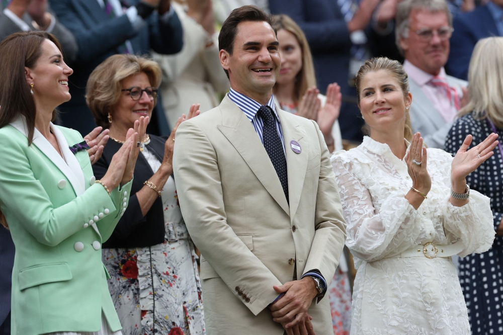 Roger Federer smiles next to his wife Mirka (right) and Britain’s Catherine, Princess of Wales, as he is given a tribute at the Centre Court, July 4, 2023. — AFP pic 