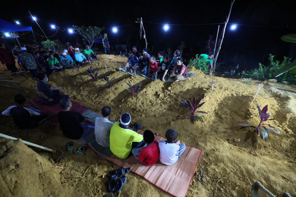 The remains of seven family members are buried in a common grave in Kuantan July 4, 2023. — Bernama pic