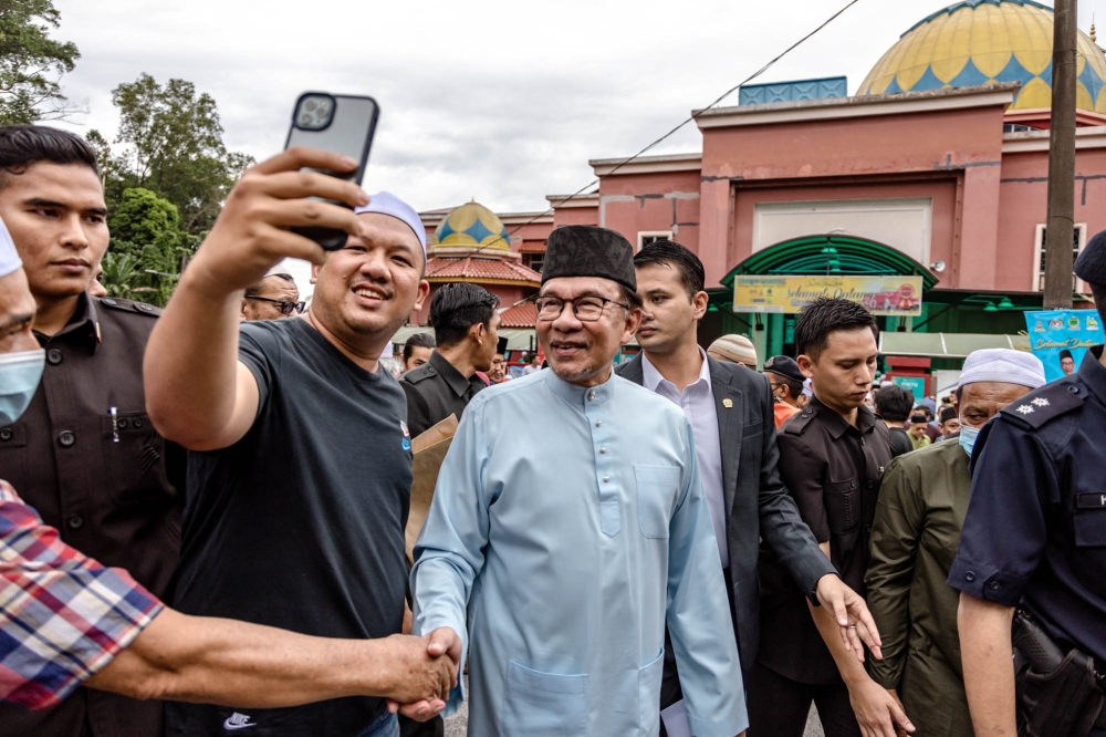 Prime Minister Datuk Seri Anwar Ibrahim greets members of the public as he leaves the Masjid Al-Khairiyah after Friday prayers in Taman Sri Gombak, Selangor July 14, 2023. ― Picture by Firdaus Latif