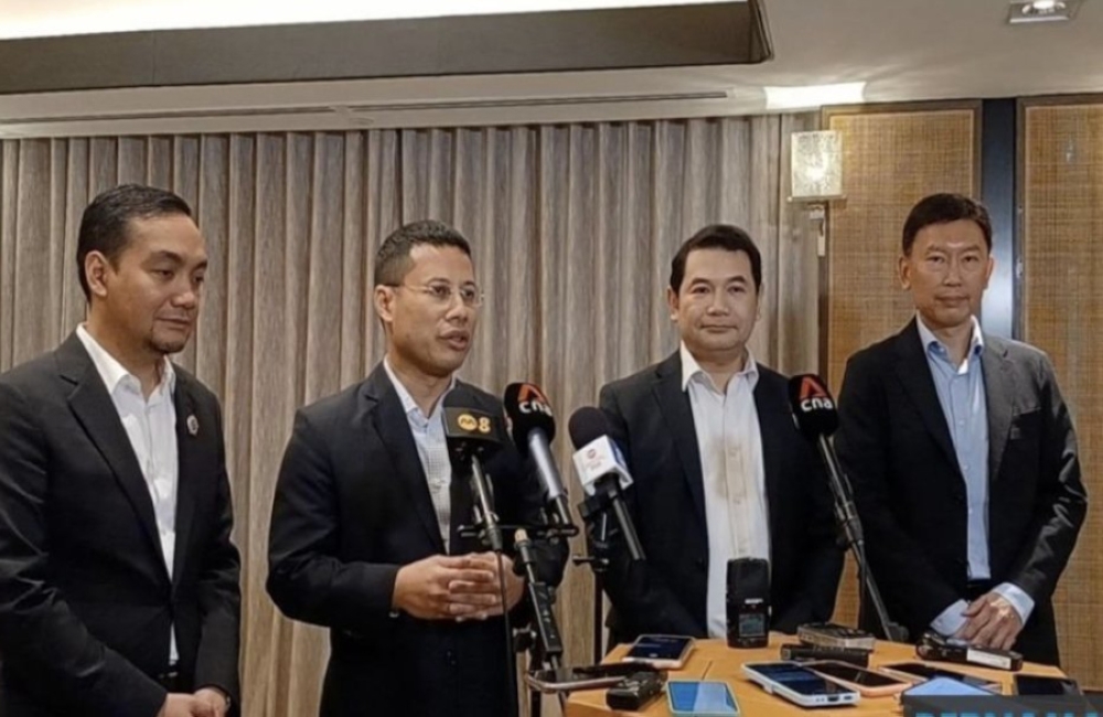 Economy Minister Rafizi Ramli and the republic’s National Development Minister Desmond Lee at a joint press conference in Singapore, July 14, 2023. — Picture from Twitter/Bernama 