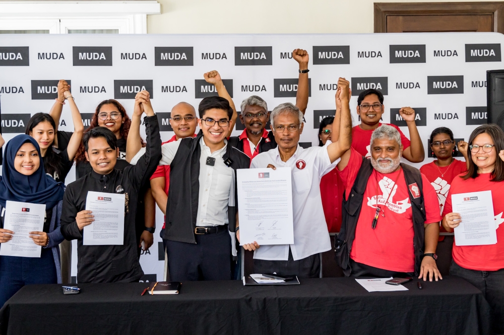 Malaysian United Democratic Alliance (Muda) president Syed Saddiq Abdul Rahman and PSM chairman Dr Michael Jeyakumar Devaraj pose for a group photo after a press conference at Bilik Gerakan Muda in Petaling Jaya July 15, 2023. — Picture by Firdaus Latif