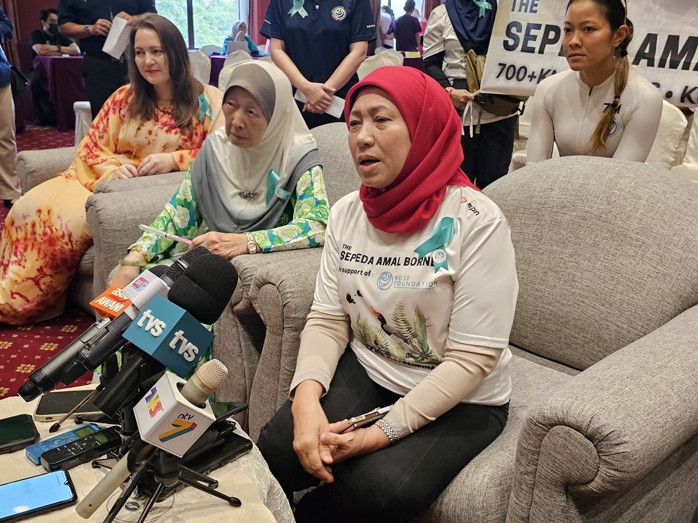 Women, Family and Community Development Minister Datuk Seri Nancy Shukri speaks to the press after officiating at the ‘Sepeda Amal Borneo’ charity cycling event in Kuching. — Borneo Post pic 