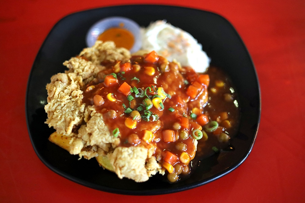 The Hainanese Chicken Chop is crispy with a tomato sauce laced with vegetables.