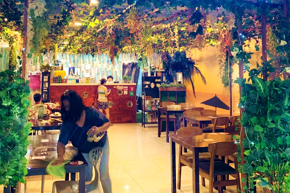 The verdant rainforest ambience of De Manila Café in Taman Desa.