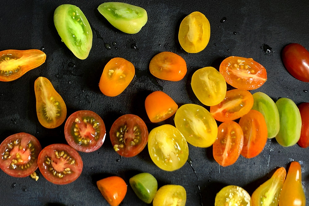 Slice the heirloom tomatoes into halves.