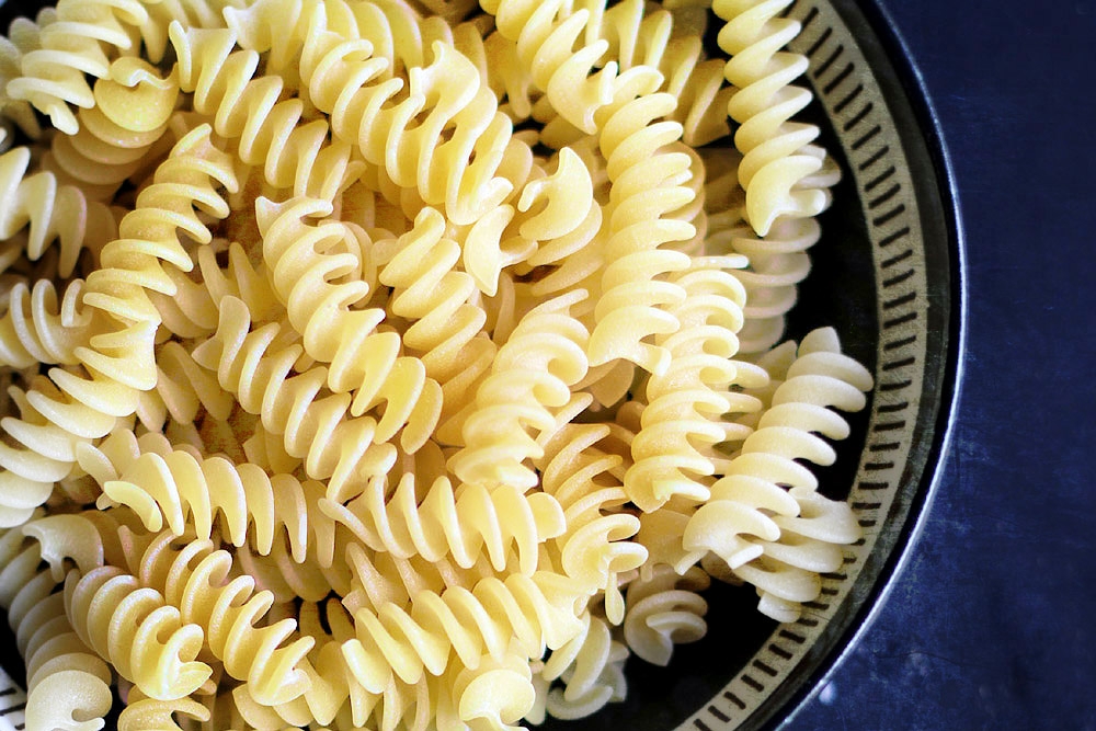 Shorter, curlier pastas such as macaroni and fusilli will retain more of the sauce in every bite.