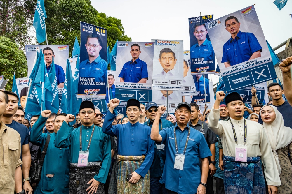 Perikatan Nasional candidates for Sungai Tua seat Muhammad Hanif Jamaluddin, Hulu Kelang seat Datuk Seri Mohamed Azmin Ali, and Gombak Setia seat Muhammad Hilman Idham seen with Perikatan Nasional chairman Tan Sri Muhyiddin Yassin during the nomination day for the upcoming Selangor state election at the nomination centre in SMK Sungai Pusu Gombak July 29, 2023. — Picture by Firdaus Latif