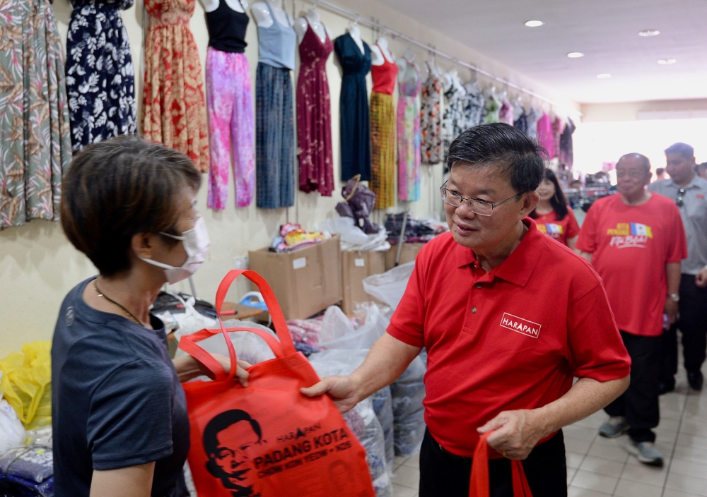 Padang Kota candidate Chow Kon Yeow greets a voter during his walkabout in George Town July 29, 2023. Also present is Tan Sri Lim Kit Siang. — Picture by KE Ooi