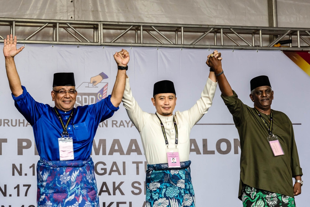 Barisan Nasional candidate Datuk Megat Zulkarnain Omardin, Perikatan Nasional candidate Muhammad Hilman Idham and Independent candidate Salim Ali vying for the Gombak Setia seat pose for a photo during nomination day ahead of the upcoming Selangor state election at the nomination centre in SMK Sungai Pusu Gombak, Selangor July 29, 2023. — Picture by Firdaus Latif