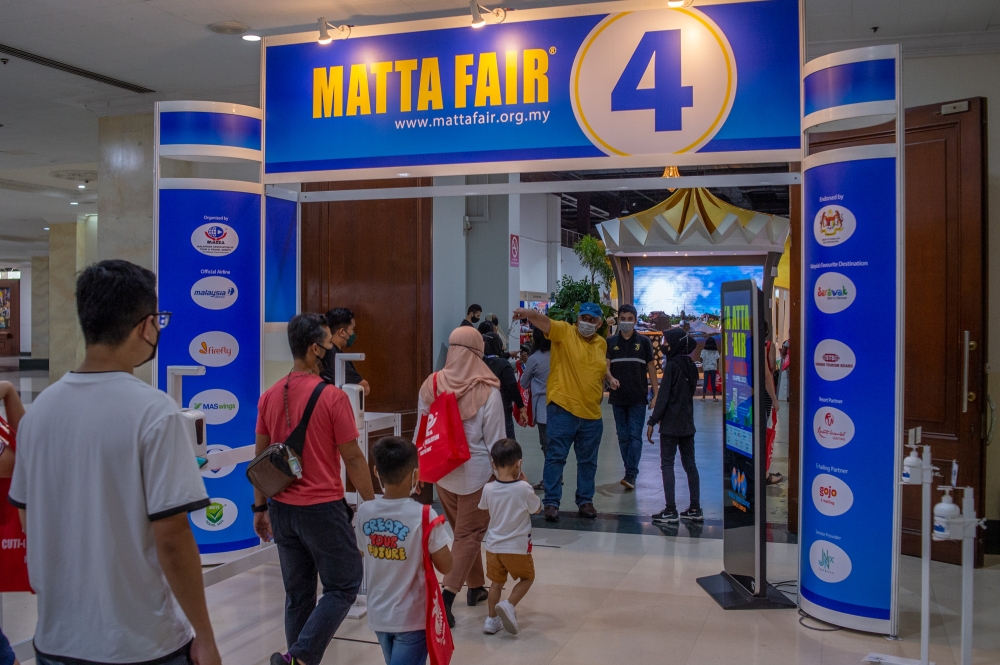 People checking out the various travel deals on offer at the 2022 Matta Fair in Kuala Lumpur April 10, 2022. ― Picture by Shafwan Zaidon