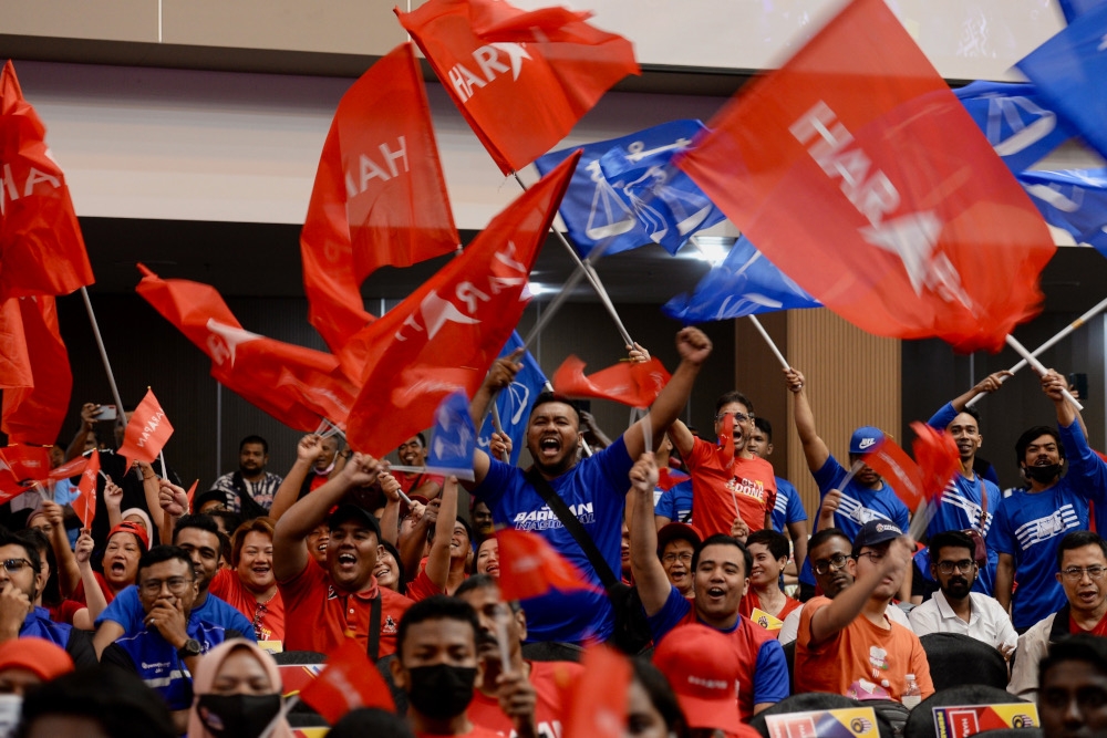 Supporters wave flags at the launch of the Penang unity manifesto, August 1, 2023. — Picture by KE Ooi